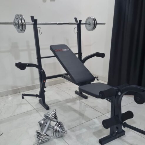 Standard weight lifting bench with 50kg barbell and dumbbell