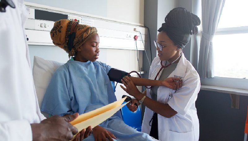 African-doctor-checks-the-blood-pressure-on-a-young-African-hospital-patient-in-Cape-Town-Sourth-Africa-1