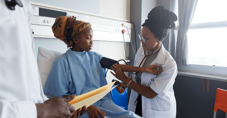 African-doctor-checks-the-blood-pressure-on-a-young-African-hospital-patient-in-Cape-Town-Sourth-Africa